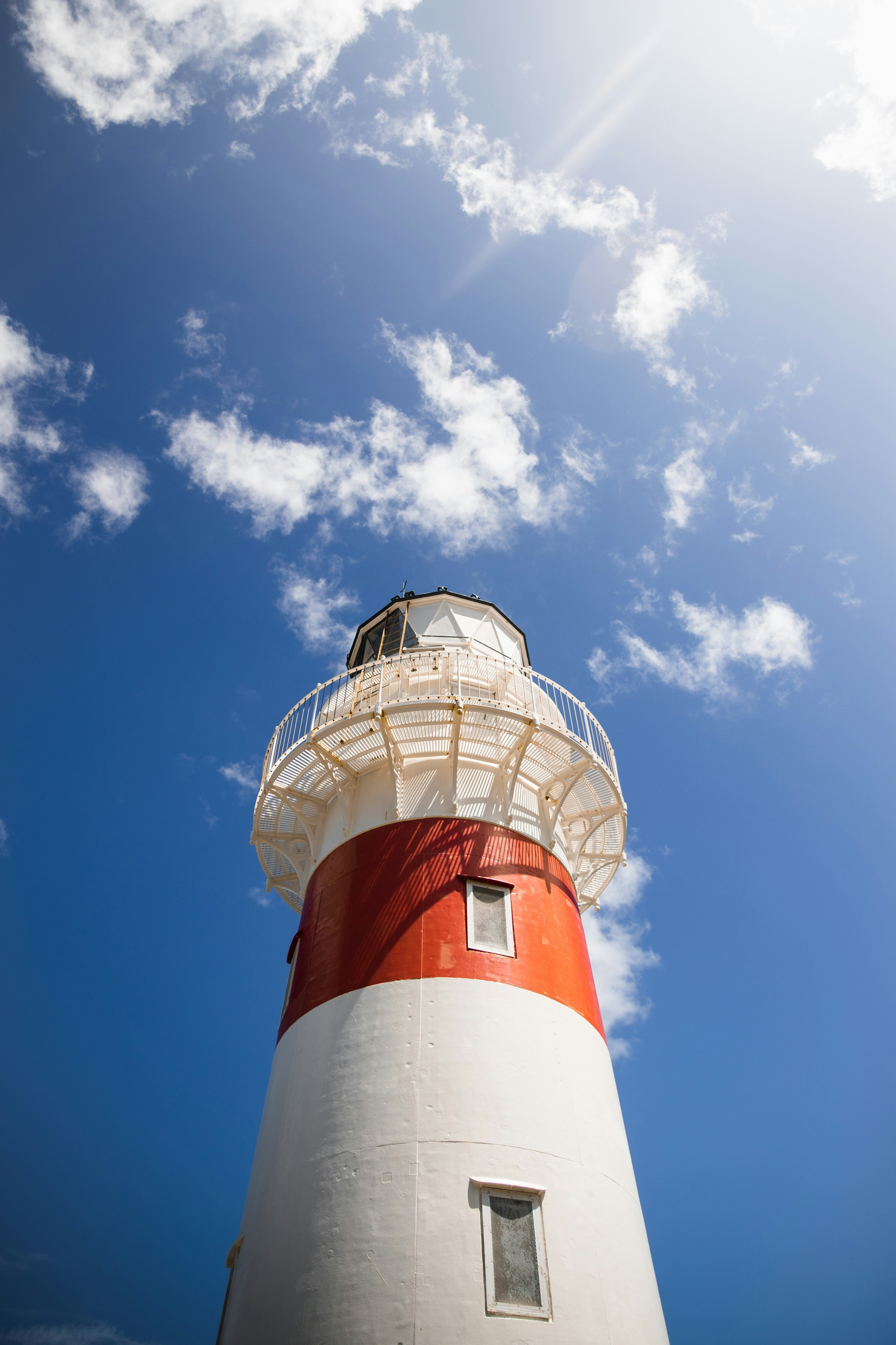 white and red lighthouse under blue sky during daytime